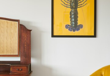 Yellow lobster poster against wall