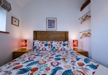 Hay Barn double bedroom with patterned bedding and bedside lamps