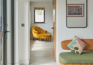 Stylish sofas against white wall